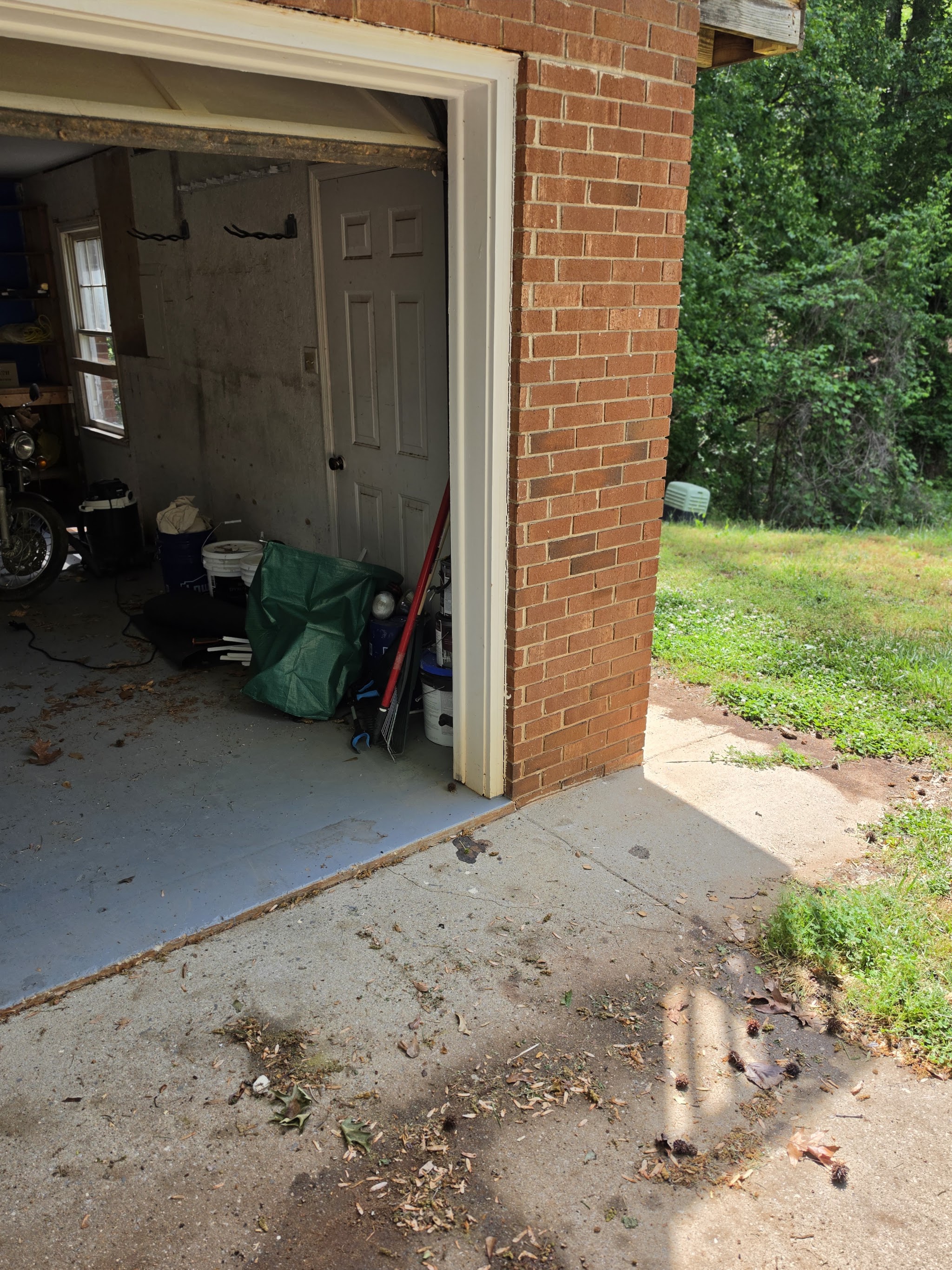 A garage cleanout in progress beside a brick wall